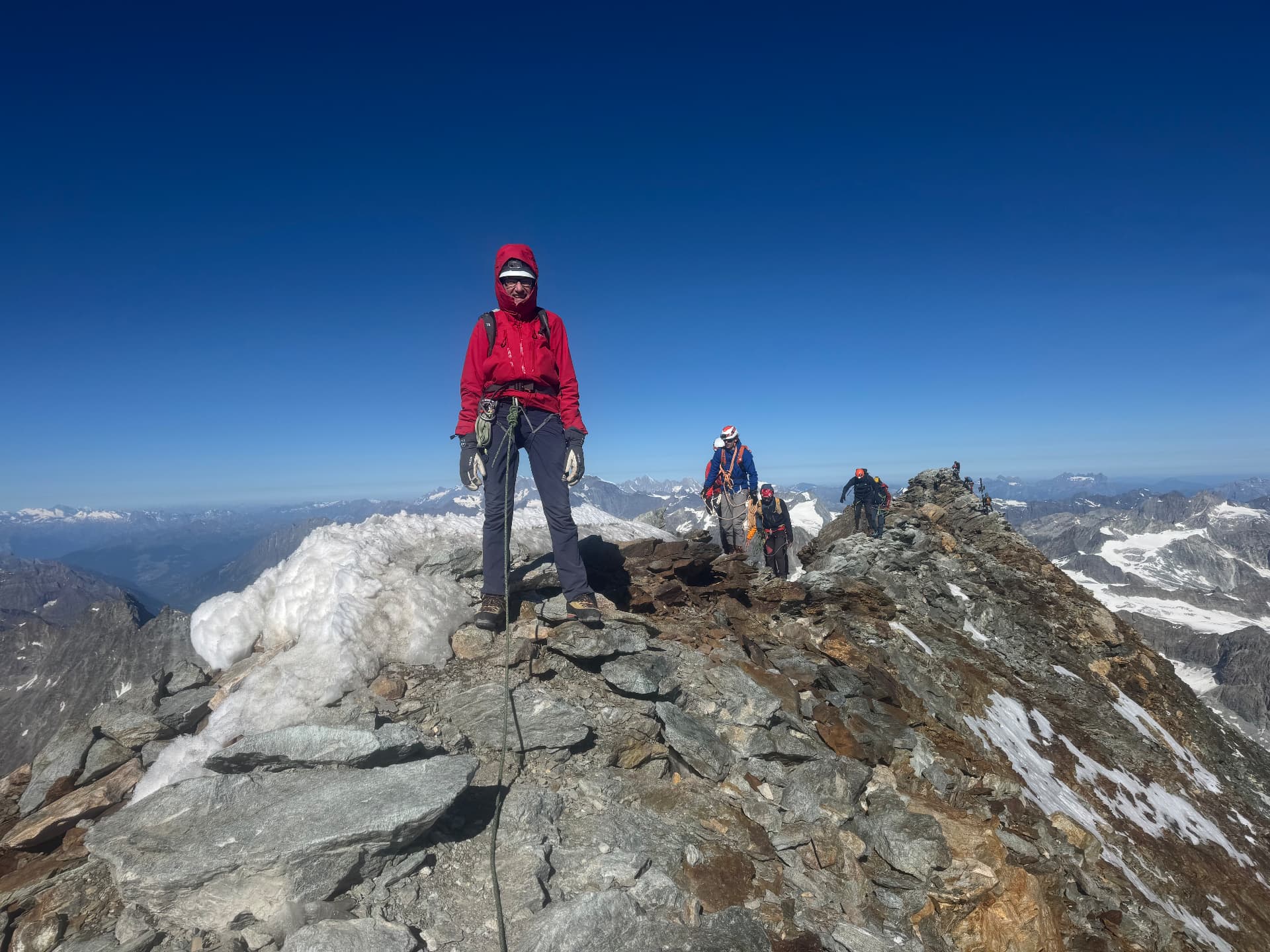 Climbers reaching a high alpine summit